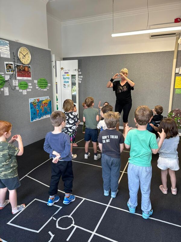 Children following group dance instructions